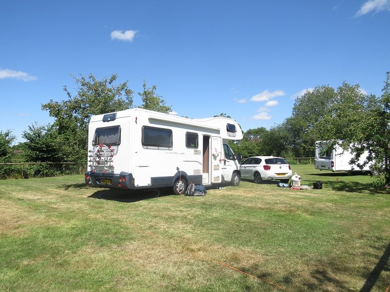 Pitched up on the grass with the hedge behind.