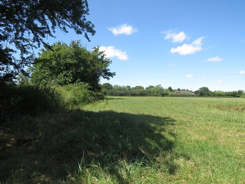 A footpath leading away from the site gate across the fields.